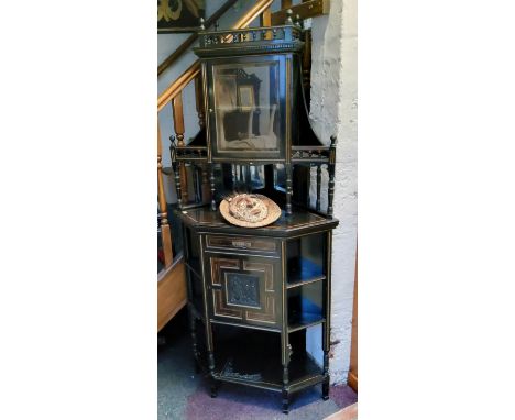 A Victorian&nbsp; amboyna and ebonised&nbsp; corner cabinet, gallery cresting, above glazed cabinet and open shelves, the pro