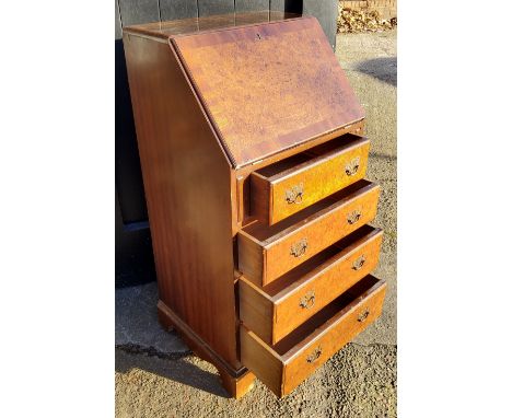 A small burr walnut bureau, fall front revealing tooled leather writing surface above four drawers, bracket feet 