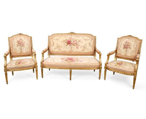 A French giltwood salon suite, of Louis XVI style, third quarter 20th century,&nbsp;comprising a canape and four fauteuils, w