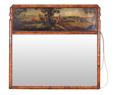 An English walnut and parcel gilt trumeau mirror, of George II style, last quarter 19th century, the shaped moulded frame wit