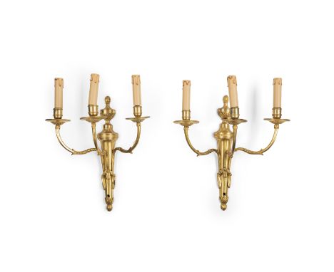 A pair of Louis XVI ormolu three-light wall appliques, late 18th / early 19th century, each with fluted tapering backplate su
