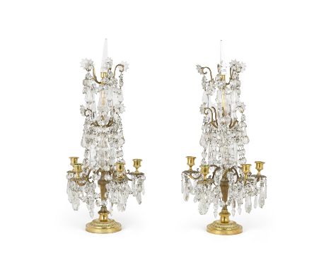 A pair of French gilt-bronze mounted glass five-light candelabra, early 20th century, associated parts, the moulded baluster 