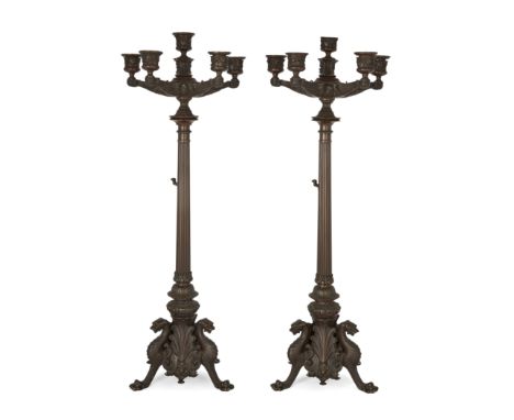 A pair of French bronze six-light candelabra, in the manner of Barbedienne, late 19th century, each cast with fruiting vine n