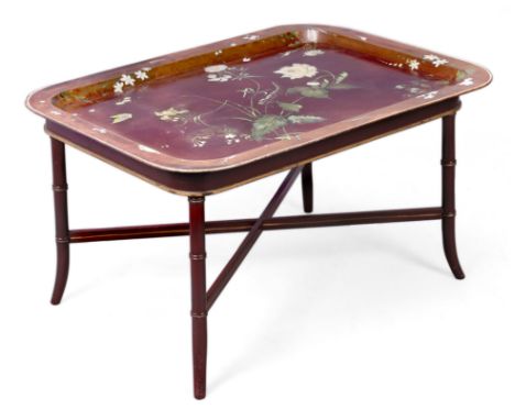 A Regency painted tole tray, first quarter 19th century, of rectangular form, the crimson ground decorated with flowers, on a