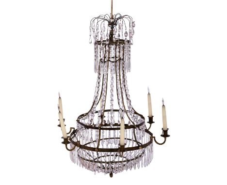 A Swedish brass and glass six-light chandelier, 19th century, the circlet with lion and lioness masks, hung overall with chai