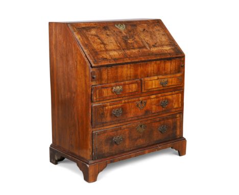 A George I inlaid walnut bureau, first quarter 18th century, the fall front with fitted interior above two short and two long