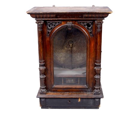 A German walnut upright coin-operated Polyphon, late 19th century, the gadrooned cornice inscribed Polyphon above an arched g