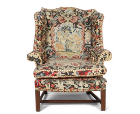 A George III mahogany wingback armchair, third quarter 18th century, with period tapestry upholstery, on chamfered legs, join