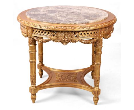 A modern Italian circular giltwood centre table, of Louis XVI style, the marble top above scrolling foliage frieze, on fluted