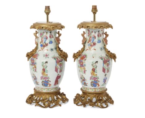 A pair of gilt-bronze mounted Chinese Canton porcelain vase lamps, 19th century, of baluster form with twin dragon handles to