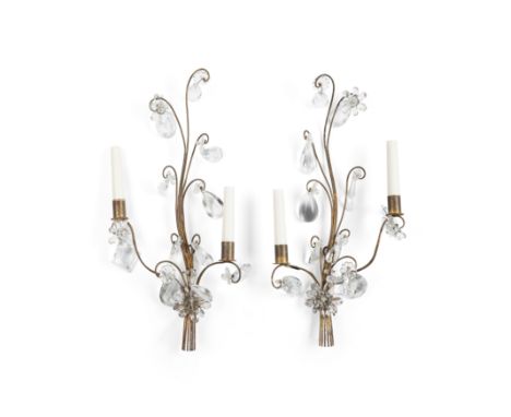 A pair of gilt-iron and glass twin-light wall appliques, in the style of Maison Bagues, second half 20th century, with facett