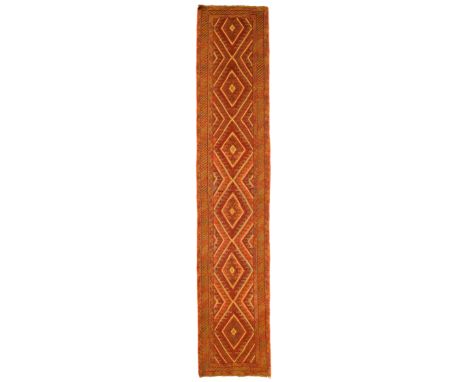 An Afghan Belouch runner, third quarter 20th century,&nbsp;the central field with six pole diamond medallion, on a multicolou