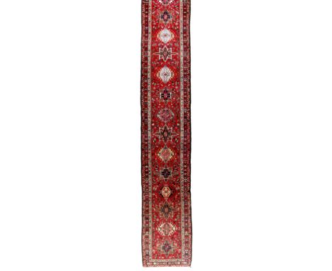 A long Persian Karaja runner, third quarter 20th century, the central field with multiple geometric medallions surrounded by 
