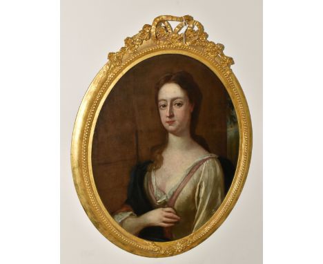 MANNER OF GODFREY KNELLER, an 18th century bust length portrait of a lady, posed against a column with landscape beyond to ri