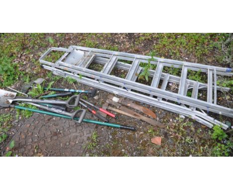 TWO ALUMINIUM STEP LADDERS, along with a quantity of gardening tools, to include a fork, shovel, axe, etc (condition report: 
