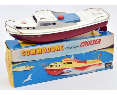 Sutcliffe tinplate clockwork Cruiser. Named 'COMMODORE' in white and red livery, with light blue hatch cover and gold painted