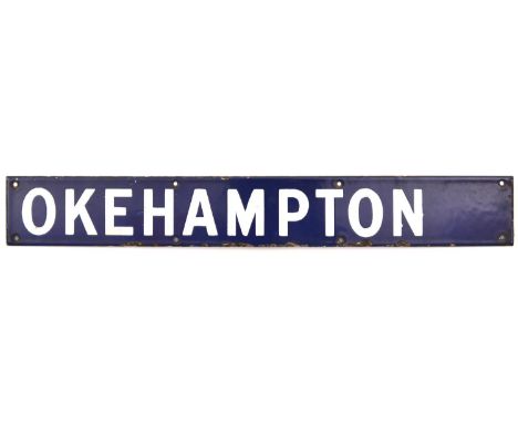 An enamel sign from a departure indicator board.  Possibly from Waterloo for the Southern Railway/BR(S) to Okehampton. White 