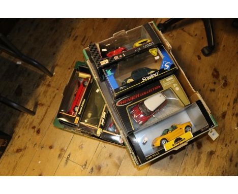 8 1:18 scale vehicles. 4x Maisto Alfa Romeo Spider in red. BMW 325i in red. Jaguar XJ220 in dark blue and a Smart Car in red/