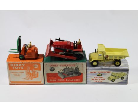 3 Dinky Toys. Blaw Knox Bulldozer (561) in red, example with black tracks. Plus a Euclid Dump Truck (965) in yellow with red 