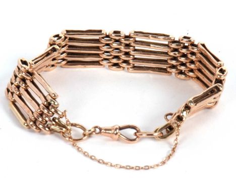 A 9c rose gold gate bracelet, with lobster clasp and safety chain, stamped 9c to one end, 17.0g