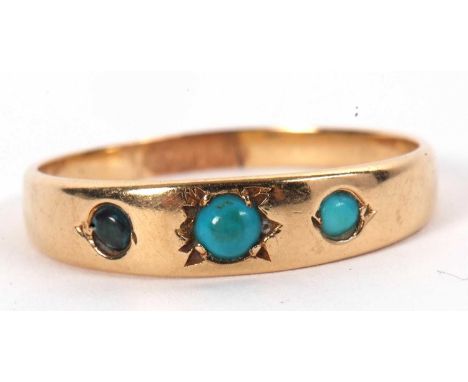 A turquoise cabochon ring, the three round graduated cabochons set in a tapered band of unmarked yellow metal (tests as appro