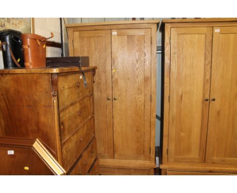 A light oak double wardrobe fitted single drawer below 