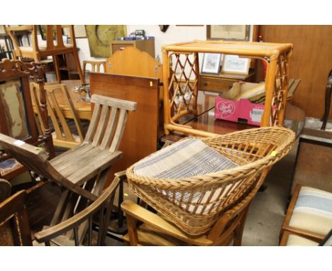 A cane back commode chair and X framed stool; two ercol stick back chairs; an oak elbow chair and a wicker chair  and a cane 