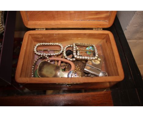 A small wooden box containing buckles, a vesta case, caddy spoon etc. 