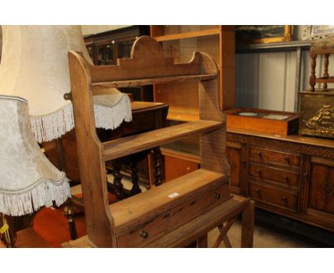 A stripped pine three tier wall shelf fitted single drawer 