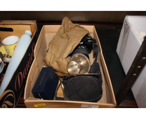 A box containing a Nikon camera ; a silver egg cup; cuff-links; various cutlery etc. 