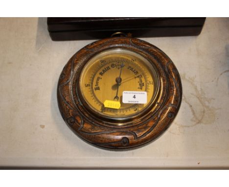 An oak cased and brass barometer 