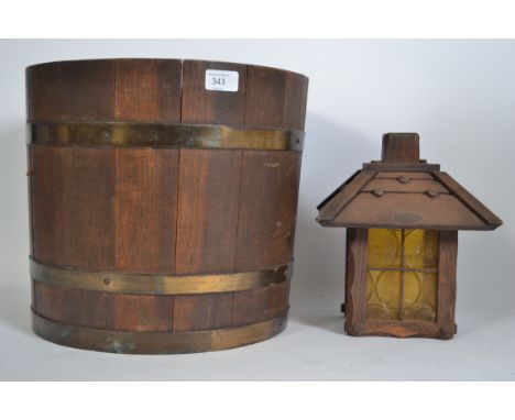 A coopered oak barrel planter having brass bindings together with a wooden arts and crafts lantern.