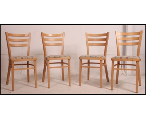 A set of 4 1950's utility vintage beech wood blond dining - kitchen chairs raised on squared legs with padded seats 80cm high
