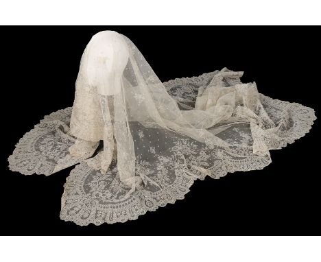 A net on net lace veil, late 19th century, the borders densely worked with scrolling blooms, scalloped edges, sprigged and sp