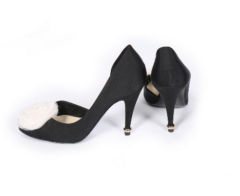 Two pairs of Chanel high-heeled shoes, modern, the first with white organza camellias to toes, the heels spiked through gilt 