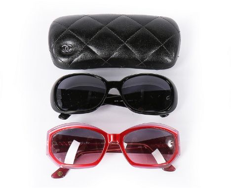 Two pairs of Chanel sunglasses, 2000s, the first with white camellias and double 'C' to frames, in original quilted leather c