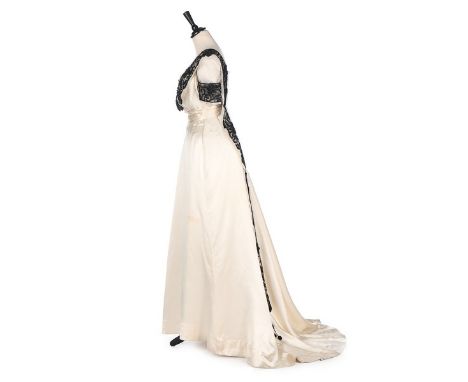 An E & J Hooper ivory satin gown, circa 1912, label to waistband, the empire-line bodice trimmed with bands of embroidered an