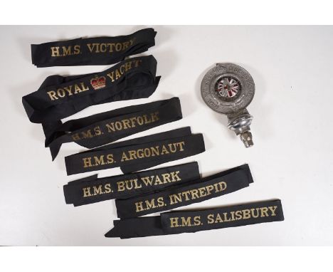 A vintage Royal Automobile Club Associate (RAC) grill badge together with a quantity of Royal Navy cap tallies. 