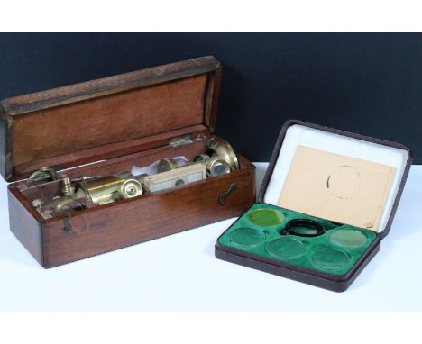 A 19th century brass field microscope within fitted wooden case, complete with slides and accessories.