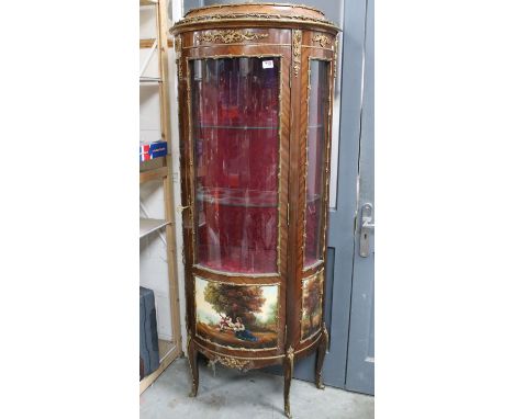 20th Century French vitrine display cabinet having a bow front with curved glass to door and upholstered interior, with gilt 