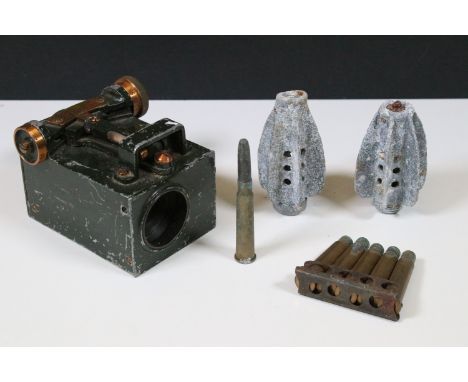 A World War Two era military clinometer together with two mortar fins and a spent round of bullet shells. 