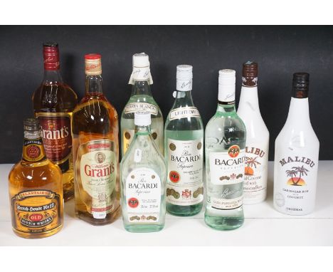 Alcohol - Nine bottles of rum and whisky to include 2 x Malibu Coconut Rum 70cl, Bacardi Carta Blanca Light-Dry Rum 1 Litre, 