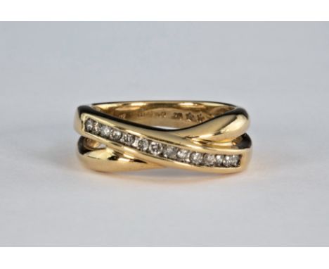 A 9ct yellow gold and diamond cross over ring, set with fourteen brilliant cut diamonds, total 0.25cts, ring size M½.