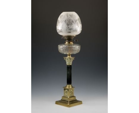 A Victorian brass and cut glass Corinthian column oil lamp, the ebonised column on a brass plinth with wreath decoration and 