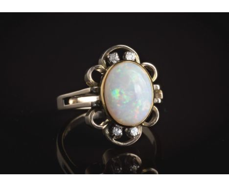 A vintage 14ct yellow gold, opal and diamond ring, 1970s, the oval cabochon opal within a floral style openwork border set wi