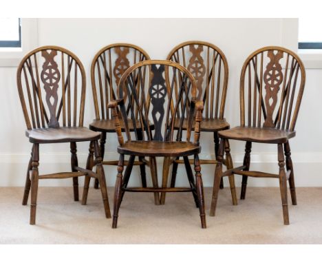 A matched set of five early 19th century beech and elm wheelback Windsor chairs, including one elbow chair, all with hooped s