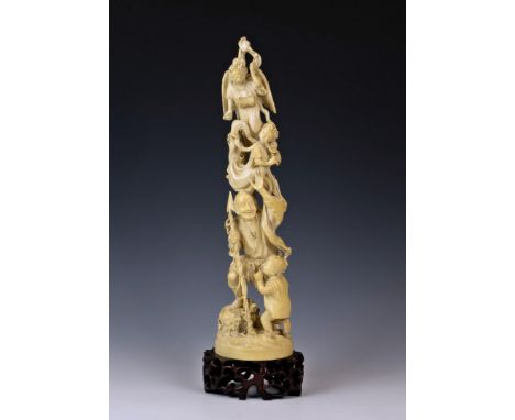 A large Japanese carved ivory figural group, Meiji period (1868-1912), the tusk carving depicting a spear fisherman and child