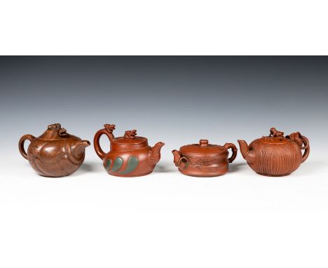 Four Chinese Yixing teapots, one of squat horizontal fluted form with bamboo design handle, the other three of melon form, on