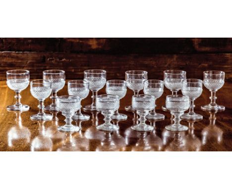 A set of six Georgian small wine glasses, the cup bowls with lower diamond and step cutting, on a flattened knopped stem and 