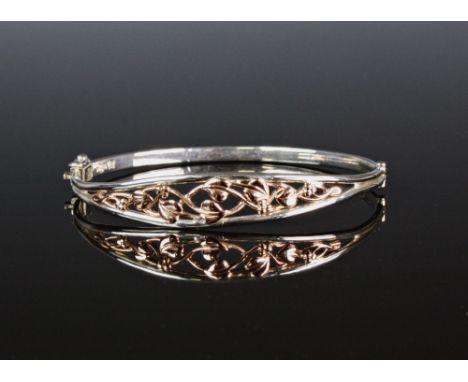 A Clogau silver and rose gold bangle, maker's hallmark and '925', the pierced bangle with meandering Art Nouveau style foliat